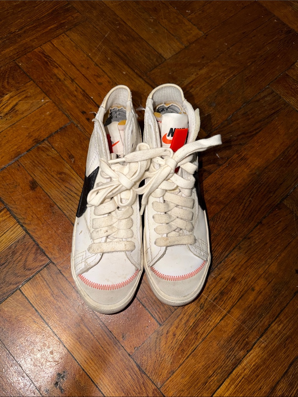 Nike White High-Top Sneakers with Black Swoosh and Red Accent